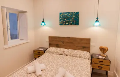 a bedroom with a bed and two night stands at Apartamento - Patio 1812 in Cádiz