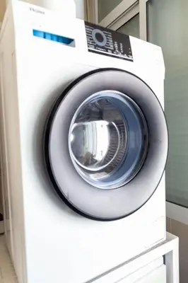 a white washing machine in a room at El Embrujo de La Caleta by Gades Gestión in Cádiz