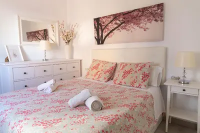 a bedroom with a bed with towels on it at El Embrujo de La Caleta by Gades Gestión in Cádiz