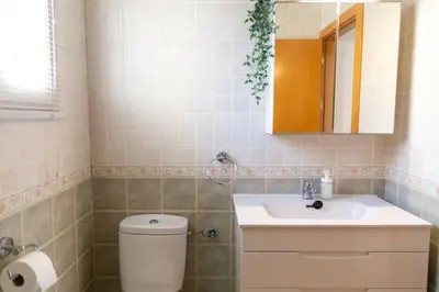 a bathroom with a toilet and a sink at El Embrujo de La Caleta by Gades Gestión in Cádiz
