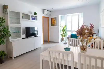 a living room with a table and a tv at El Embrujo de La Caleta by Gades Gestión in Cádiz