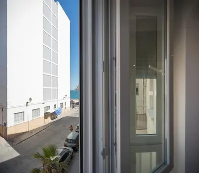 a room with a window with a view of a street at El Embrujo de La Caleta by Gades Gestión in Cádiz