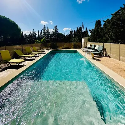 a swimming pool with chaise lounge chairs and a swimming pool at Agradable casa de campo con piscina en la Barrosa in Chiclana de la Frontera