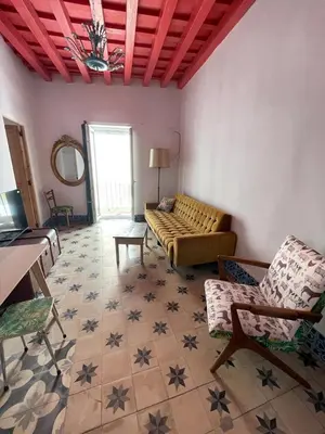 a living room with a couch and a table and chairs at Apartamentos la Selva - Rafael de la Viesca in Cádiz