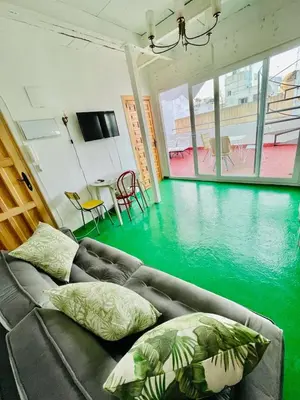 a living room with a couch and a pool of water at Apartamentos la Selva - Rafael de la Viesca in Cádiz