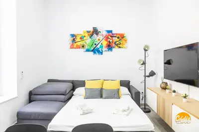 a living room with a couch and a flat screen tv at El Arco del Fotografo by Cadiz Time in Cádiz