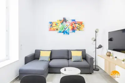 a living room with a couch and a table at El Arco del Fotografo by Cadiz Time in Cádiz