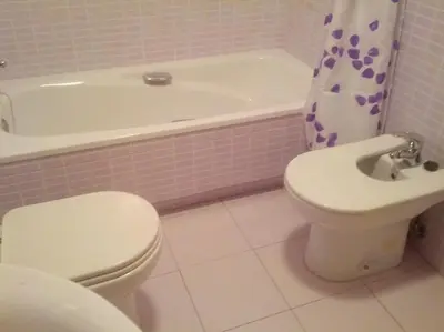 a bathroom with a toilet and a bath tub and a sink at Piso con parking en el edificio, Rio san pedro, CADIZ in El Trocadero