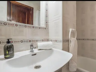 a bathroom with a white sink and a mirror at Cañailla in San Fernando