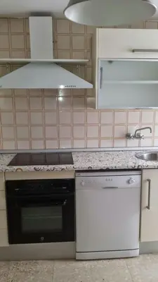a kitchen with a stove top oven and a sink at Cañailla in San Fernando