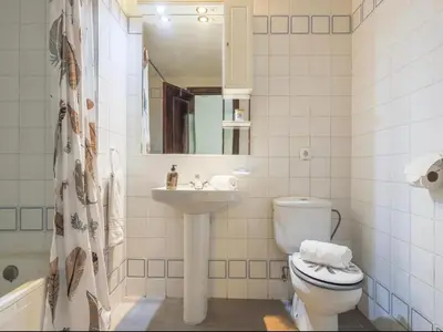 a bathroom with a toilet and a sink and a mirror at Cañailla in San Fernando