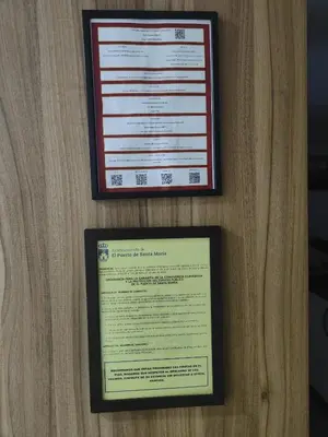 two certificates are hanging on a wall at Apartamento Las Dunas in El Puerto de Santa María
