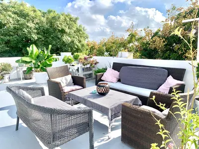 a patio with chairs and a couch and a table at Ático Plaza España in Jerez de la Frontera