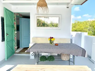 a patio with a table and a window at Ático Plaza España in Jerez de la Frontera