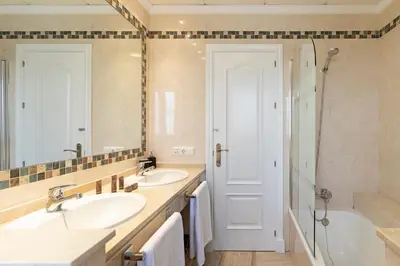 a bathroom with two sinks and a tub and a shower at Genteel Home Mirador de La Barrosa in Chiclana de la Frontera