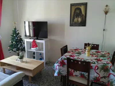a living room with a christmas tree and a table at Casa Petra in Arcos de la Frontera