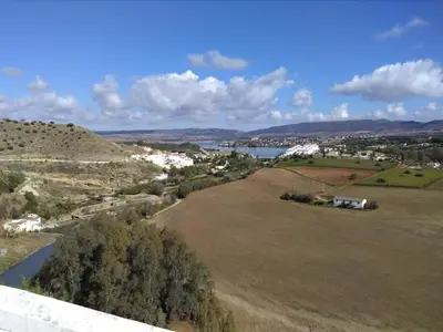 an aerial view of a field with a river and a town at Casa Petra in Arcos de la Frontera