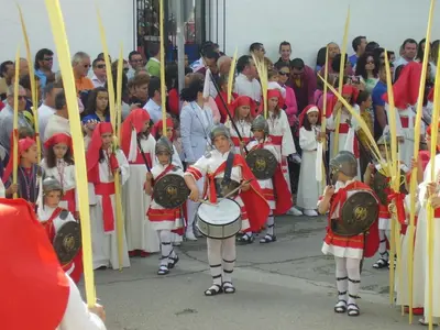 a group of children playing drums in a parade at Casa Petra in Arcos de la Frontera