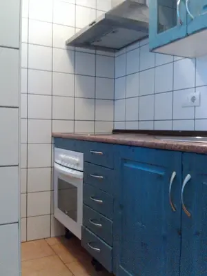 a kitchen with blue cabinets and an oven at Casa Petra in Arcos de la Frontera