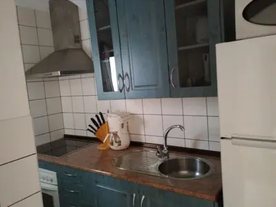 a kitchen with blue cabinets and a sink at Casa Petra in Arcos de la Frontera