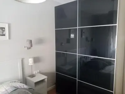 a bedroom with a large glass partition with a bed at Paseo marítimo de Cádiz in Cádiz