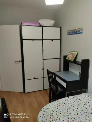 a bedroom with a bed and a desk and a bed and a table at Paseo marítimo de Cádiz in Cádiz