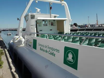 a boat with a sign on the side of it at Paseo marítimo de Cádiz in Cádiz
