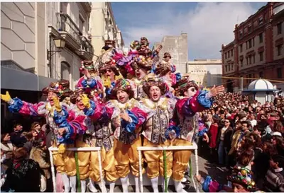 a group of people dressed in costumes in a parade at Paseo marítimo de Cádiz in Cádiz