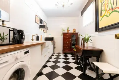 a kitchen with a black and white checkered floor at Sherryflat Corredera Terrace in Jerez de la Frontera