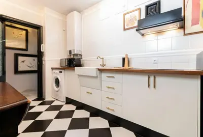 a kitchen with a black and white checkered floor at Sherryflat Corredera Terrace in Jerez de la Frontera
