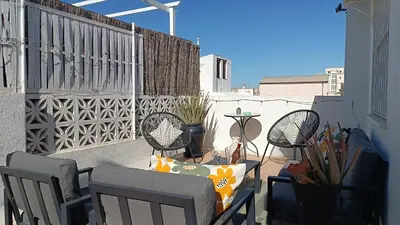 a patio with three chairs and a table on a balcony at Sherryflat Corredera Terrace in Jerez de la Frontera