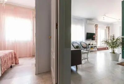 a living room with a bed and a dining room at Sherryflat Corredera Terrace in Jerez de la Frontera