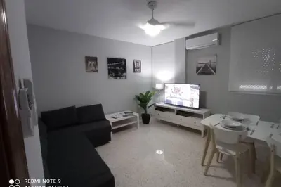 a living room with a couch and a tv at Apartamento cabañiles wifi in Jerez de la Frontera