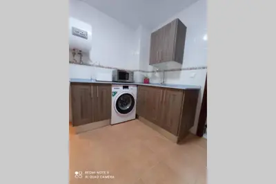 a kitchen with a washer and a washing machine at Apartamento cabañiles wifi in Jerez de la Frontera