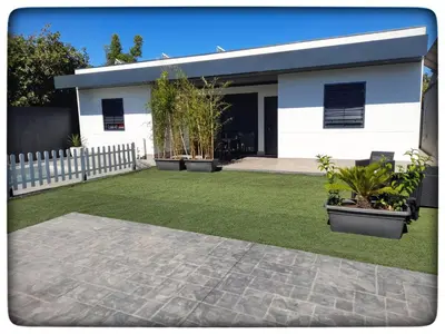 a white house with a lawn in front of it at Sirocco in Chiclana de la Frontera
