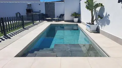 a swimming pool with blue water in a house at Sirocco in Chiclana de la Frontera