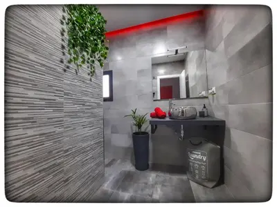 a bathroom with a shower with a sink and a mirror at Sirocco in Chiclana de la Frontera