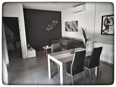 a living room with a table and a couch at Sirocco in Chiclana de la Frontera