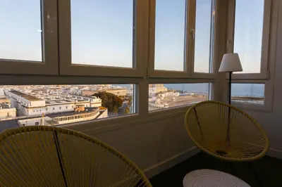 two chairs in a room with a view of a city at ATLANTICO Family Home by Cadiz4Rentals in Cádiz