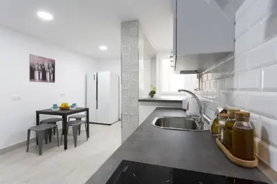 a kitchen with a sink and a table at ATLANTICO Family Home by Cadiz4Rentals in Cádiz
