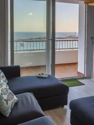 a living room with a couch and a view of the ocean at ATLANTICO Family Home by Cadiz4Rentals in Cádiz