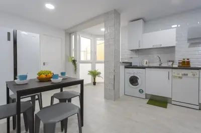 a kitchen with a table and chairs in a room at ATLANTICO Family Home by Cadiz4Rentals in Cádiz