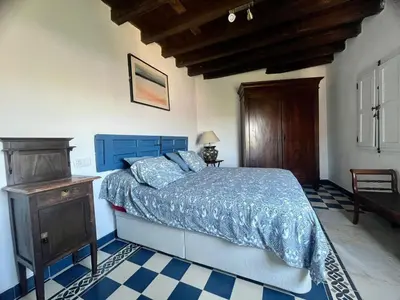 a bedroom with a blue bed and a wooden ceiling at Mirador Villa Perla Grupo AC Gestion in Arcos de la Frontera