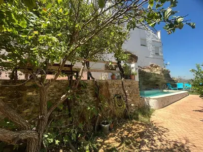 a house with a swimming pool next to a tree at Mirador Villa Perla Grupo AC Gestion in Arcos de la Frontera
