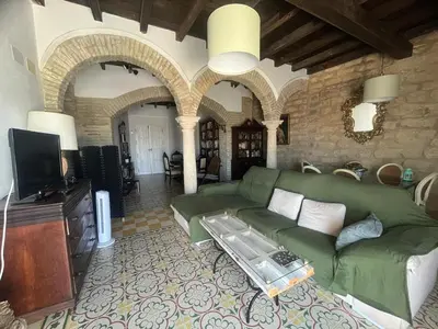 a living room with a green couch and a tv at Mirador Villa Perla Grupo AC Gestion in Arcos de la Frontera
