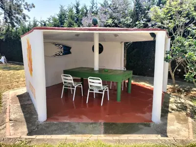 a tent with a green table and two chairs at SOLECITO in Chiclana de la Frontera