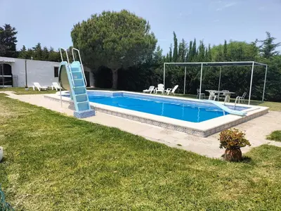 a swimming pool with a slide in a yard at SOLECITO in Chiclana de la Frontera