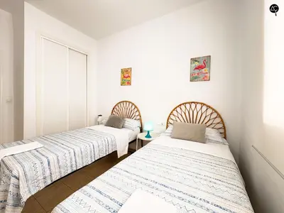 two beds in a room with white walls at Penthouse Mara Ascensor y Playa Grupo AC Gestion in Cádiz