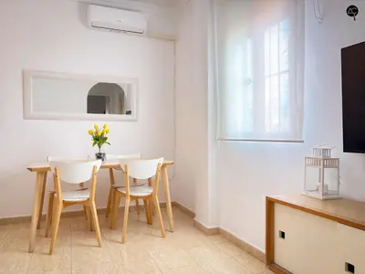 a dining room with a table and chairs at Penthouse Mara Ascensor y Playa Grupo AC Gestion in Cádiz