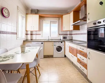 a kitchen with a table and a sink and a dishwasher at Penthouse Mara Ascensor y Playa Grupo AC Gestion in Cádiz